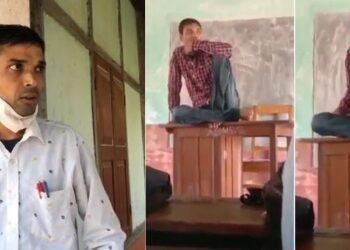 এগৰাকী শিক্ষকৰ Viral Video; বহিবলৈ নালাগে চকী, লাগে টেবুল! টেবুলৰ ওপৰত বহিয়েই কৰে পাঠদান, পিছে শিক্ষকৰ ভাষ্য কি শুনক…